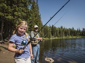 USA, Utah, Lake City, Girl (4-5) with grandfather fishing in lake
