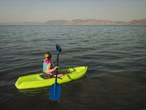 Girl (4-5) kayaking on lake