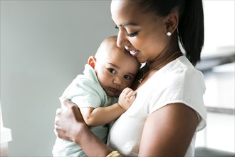 Portrait of mother holding baby boy (2-5 months)