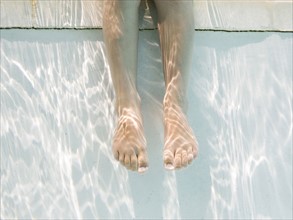 Legs of girl (4-5) underwater