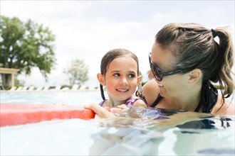 Mother with daughter (4-5) in swimming pool