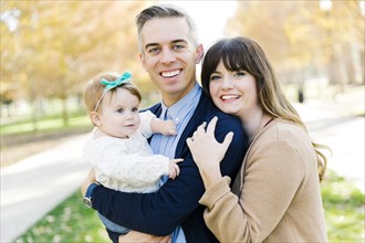 Parents with daughter (12-17 months) in park