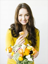 Portrait of woman holding flowers