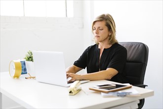 Mature woman working on laptop