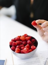 Selective focus on bowl with raspberries