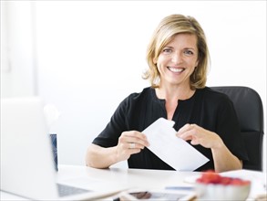 Portrait of Mature woman opening letter