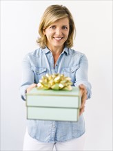 Portrait of Mature woman giving gift