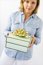 Portrait of Mature woman holding gift