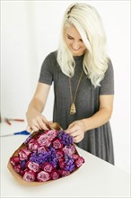 Woman wrapping bouquet with roses