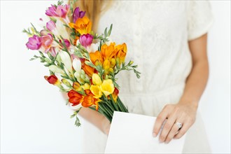 Woman holding bouquet and letter