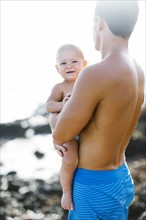 Man holding baby son (18-23 months)