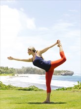 USA, Hawaii, Kauai, Woman stretching on sunny day