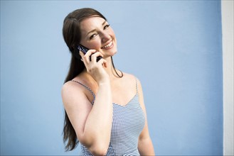 Cheerful woman during phone conversation