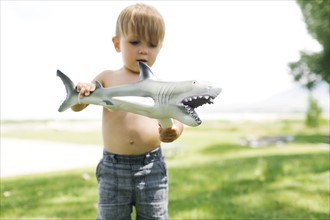 Boy (2-3) playing with toy shark