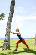 USA, Hawaii, Kauai, Woman exercising near sea