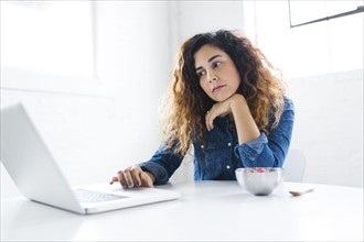 Portrait of mid adult woman using laptop