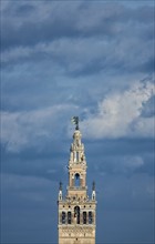 Spain, Seville, Top of Giralda Tower against clouds