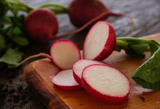 Slices of red radish on cutting board