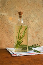 Olive oil bottle with rosemary leaves