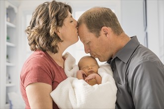 Parents holding and baby son (0-1 months)
