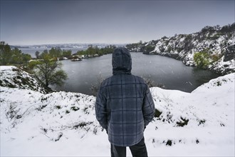 Ukraine, Dnepropetrovsk region, Dnepropetrovsk city, Person looking over winter landscape with lakes
