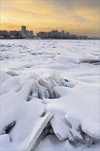 Ukraine, Dnepropetrovsk region, Dnepropetrovsk city, Frozen river with distant cityscape