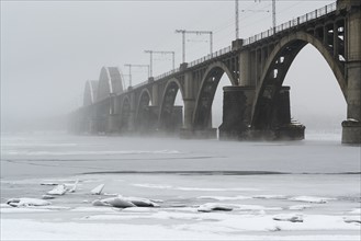 Ukraine, Dnepropetrovsk region, Dnepropetrovsk city, Bridge over frozen river