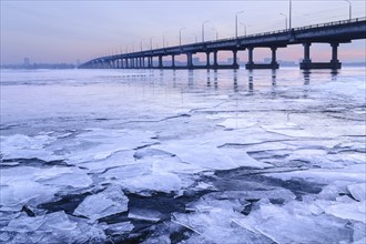 Ukraine, Dnepropetrovsk region, Dnepropetrovsk city, Bridge over frozen river