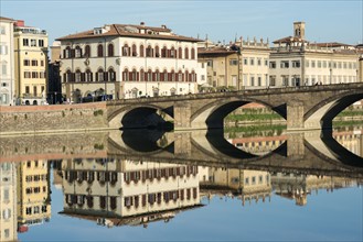 Italy, Tuscany, Florence, Bridge reflected in Arno river