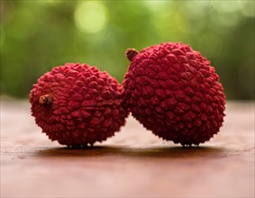 Two lychee on table