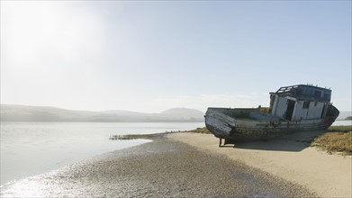 USA, California, Inverness, Point Reyes, Tomales Bay, Shipwreck on sandy coast