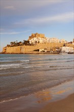 Spain, Valencian Community, Peniscola, Waterfront town on hill with sea in foreground