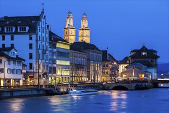 Switzerland, Zurich, Grossmunster Church and Limmat River, City scene at promenade at night