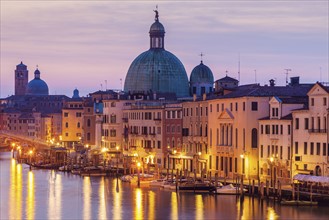 Italy, Veneto, Venice, Street light reflecting in water with Dome of Santa Maria della Salute Basilica
