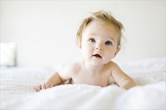 Portrait of baby girl (6-11 Months) with mouth open and tousled hair