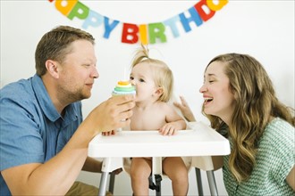 Mother and father celebrating first birthday of daughter (12-17 months)