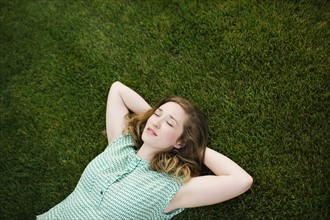 Woman lying on grass and sleeping
