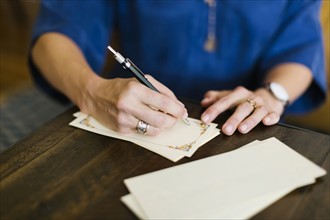 Close-up of woman writing letter