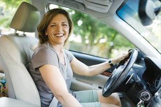 Portrait of smiling woman driving car