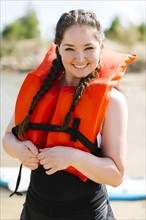 Portrait of smiling woman in life jacket