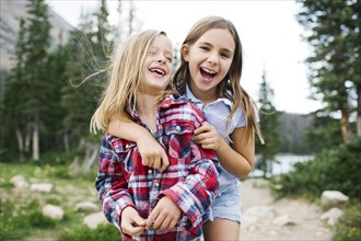 Brother (6-7) and sister ( 8-9) playing in forest