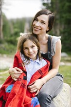 Portrait of mother with daughter (8-9) in forest