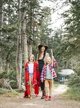 Mother with son (6-7) and daughter (8-9) hiking in forest