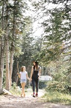 Mother with daughter (8-9) hiking in forest
