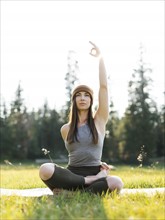 Woman practicing yoga in forest