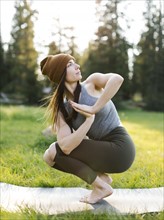 Woman practicing yoga in forest