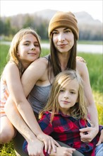 Portrait of mother with son (6-7) and daughter (8-9) in meadow