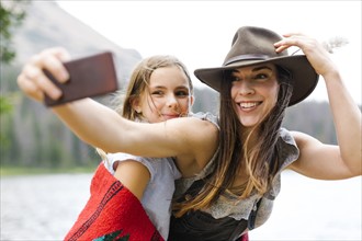 Mother and daughter (8-9) taking selfie