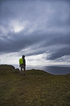 Ireland, County Donegal, Hiker looking at Donegal bay along Wild Atlantic Way