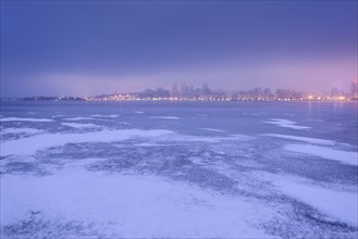 Ukraine, Dnepropetrovsk region, Dnepropetrovsk city, Dramatic sky over frozen river at dusk